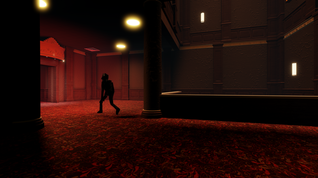 A dim red-lit corridor inside the theatre, with wall sconces over red carpet and a lone figure walking in the distance